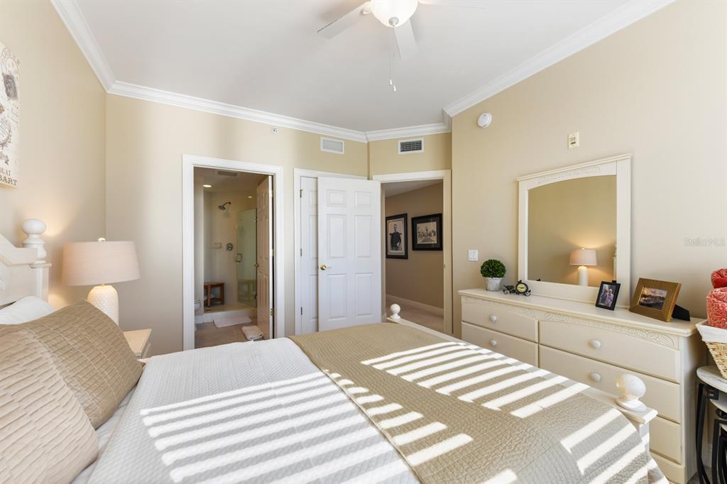 3333 Sunset Key Circle, Unit 407 Punta Gorda, FL 33955 - Photo 42 of 78 a bedroom with a bed and a large mirror with a dresser