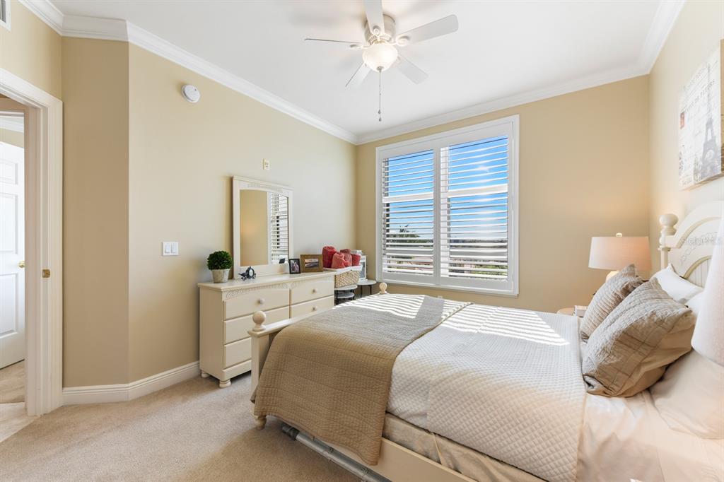 3333 Sunset Key Circle, Unit 407 Punta Gorda, FL 33955 - Photo 45 of 78 a bedroom with a bed and a chandelier