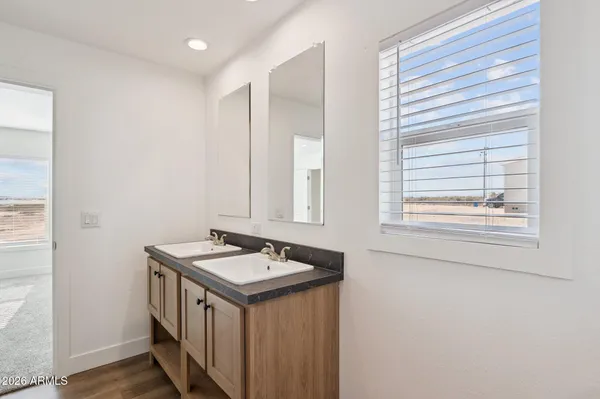 a bathroom with a sink a vanity and a window