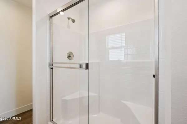 a bathroom with a glass shower door