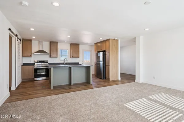 a kitchen with stainless steel appliances granite countertop a refrigerator sink and cabinets