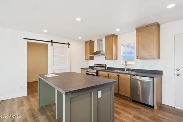 a kitchen with a sink stove and cabinets
