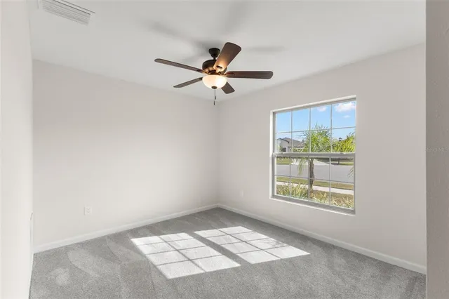 a view of an empty room and a window