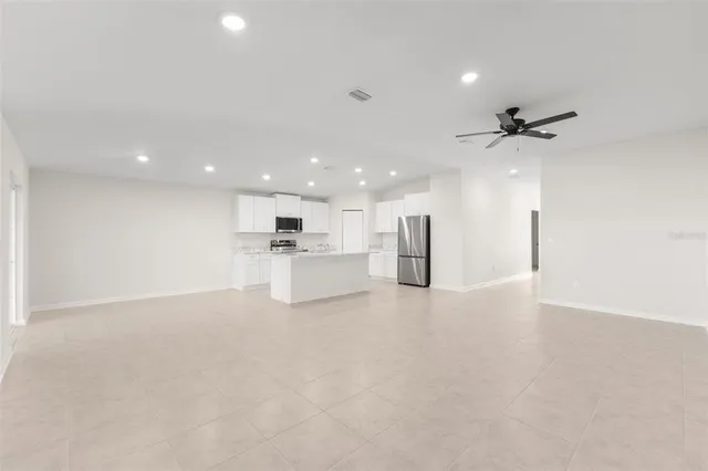 a view of a kitchen with a sink and a refrigerator