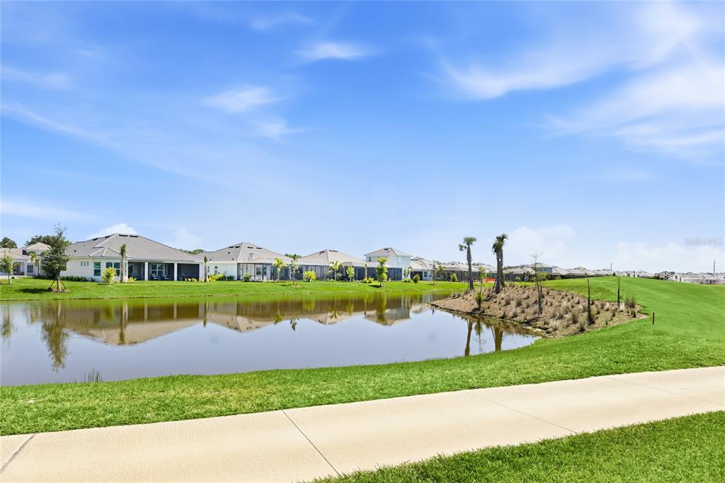 19156 Cherrystone Way Lakewood Ranch, FL 34211 - Photo 35 of 49 a view of a lake with houses in the back