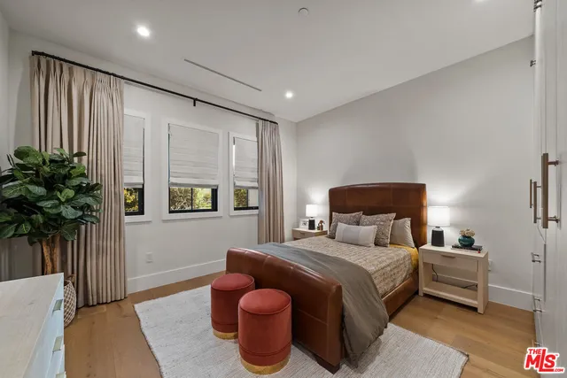 a bedroom with bed and a potted plant