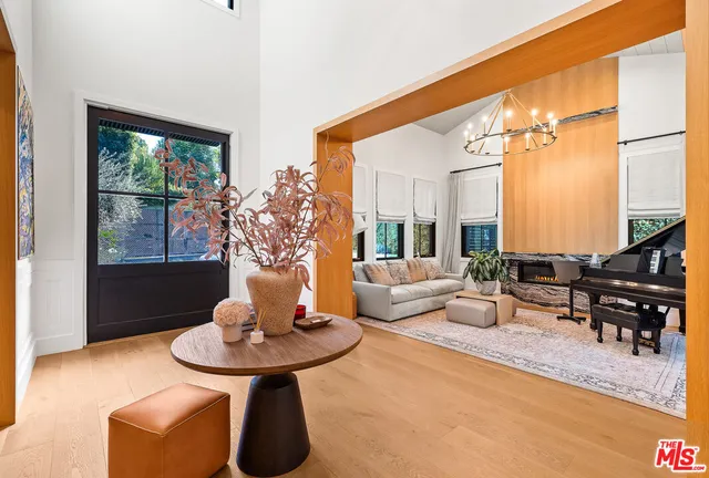 a living room with fireplace furniture and a large window