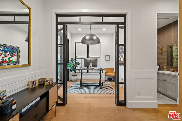 a living room with furniture and a mirror