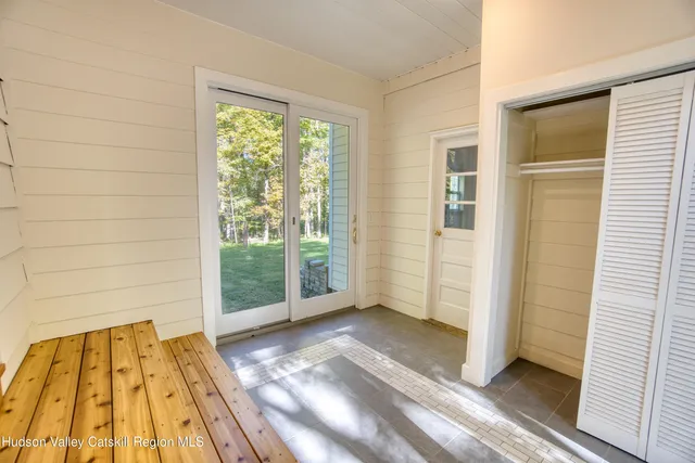 a view of a room with wooden floor and windows