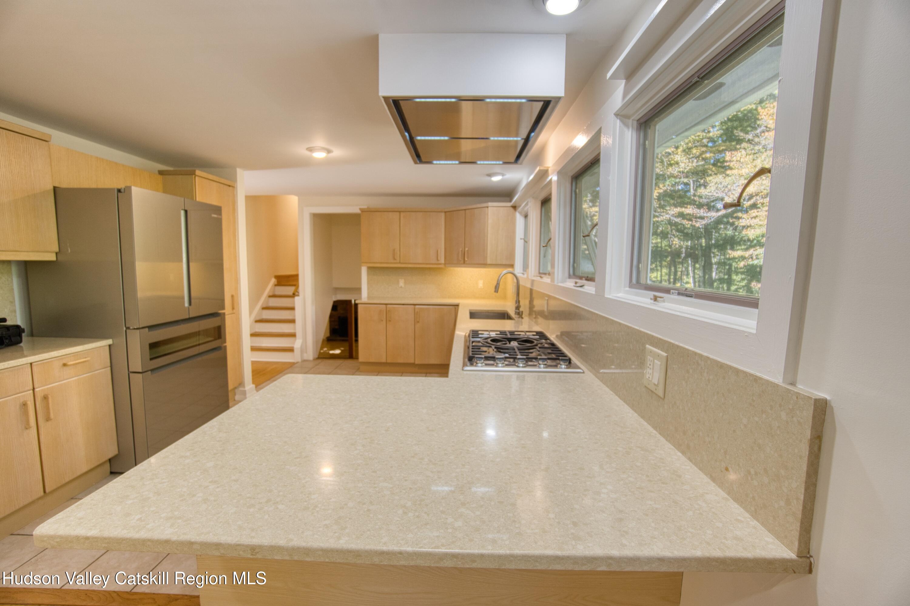 177 Buck Road Stone Ridge, NY 12484 - Photo 16 of 37 a large white kitchen with a large window