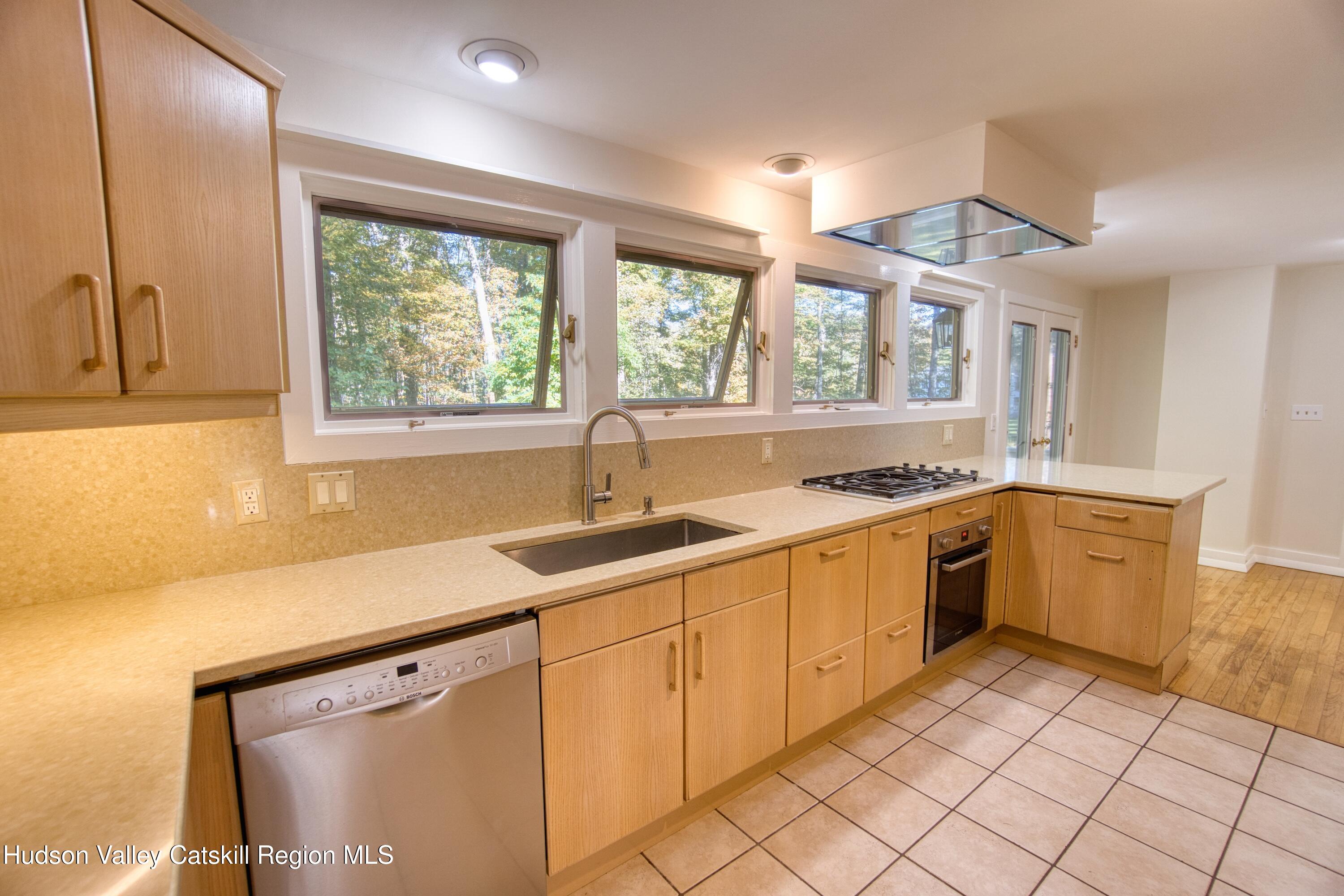 177 Buck Road Stone Ridge, NY 12484 - Photo 17 of 37 a kitchen with a sink window and cabinets