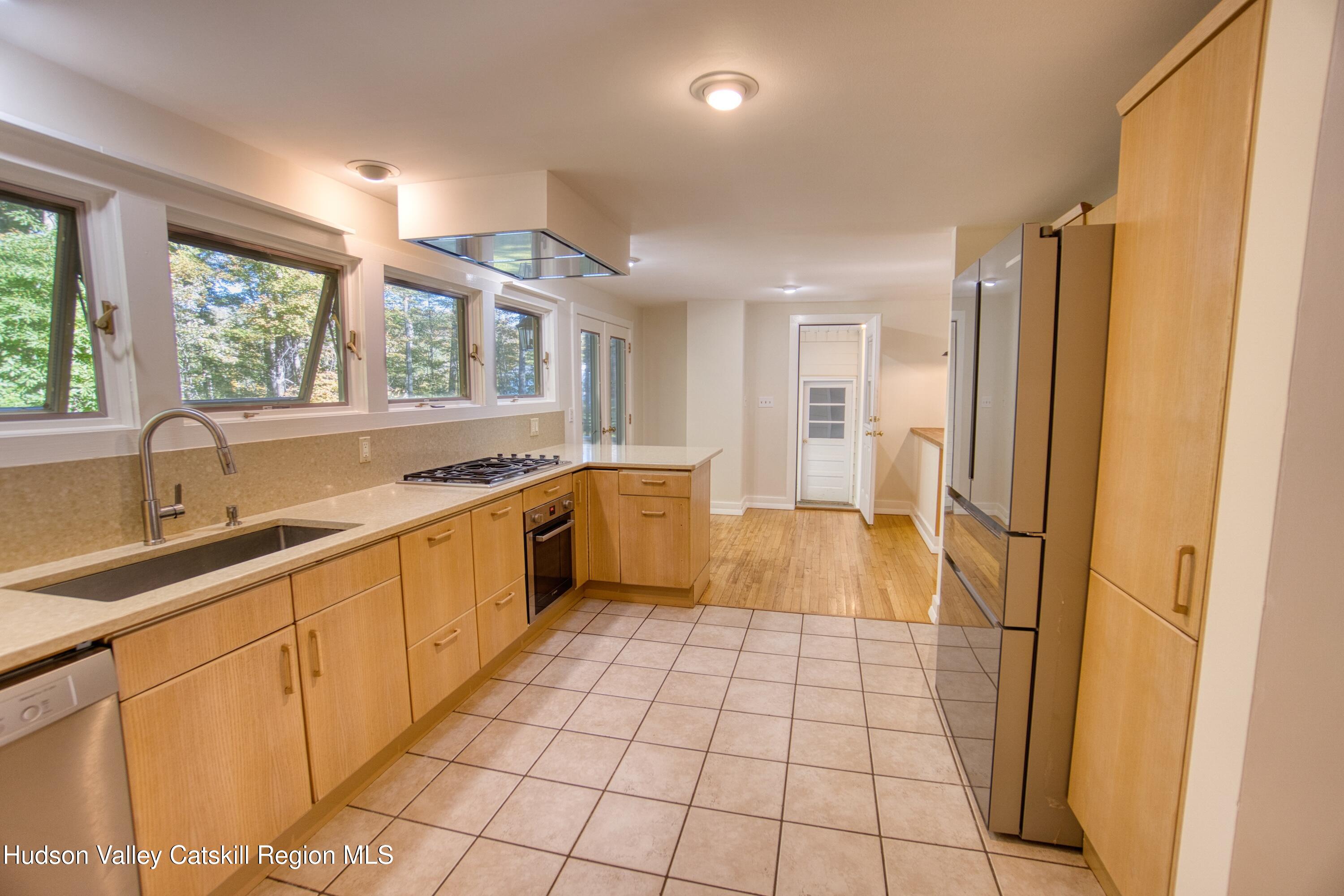177 Buck Road Stone Ridge, NY 12484 - Photo 18 of 37 a large kitchen with a sink and a large window