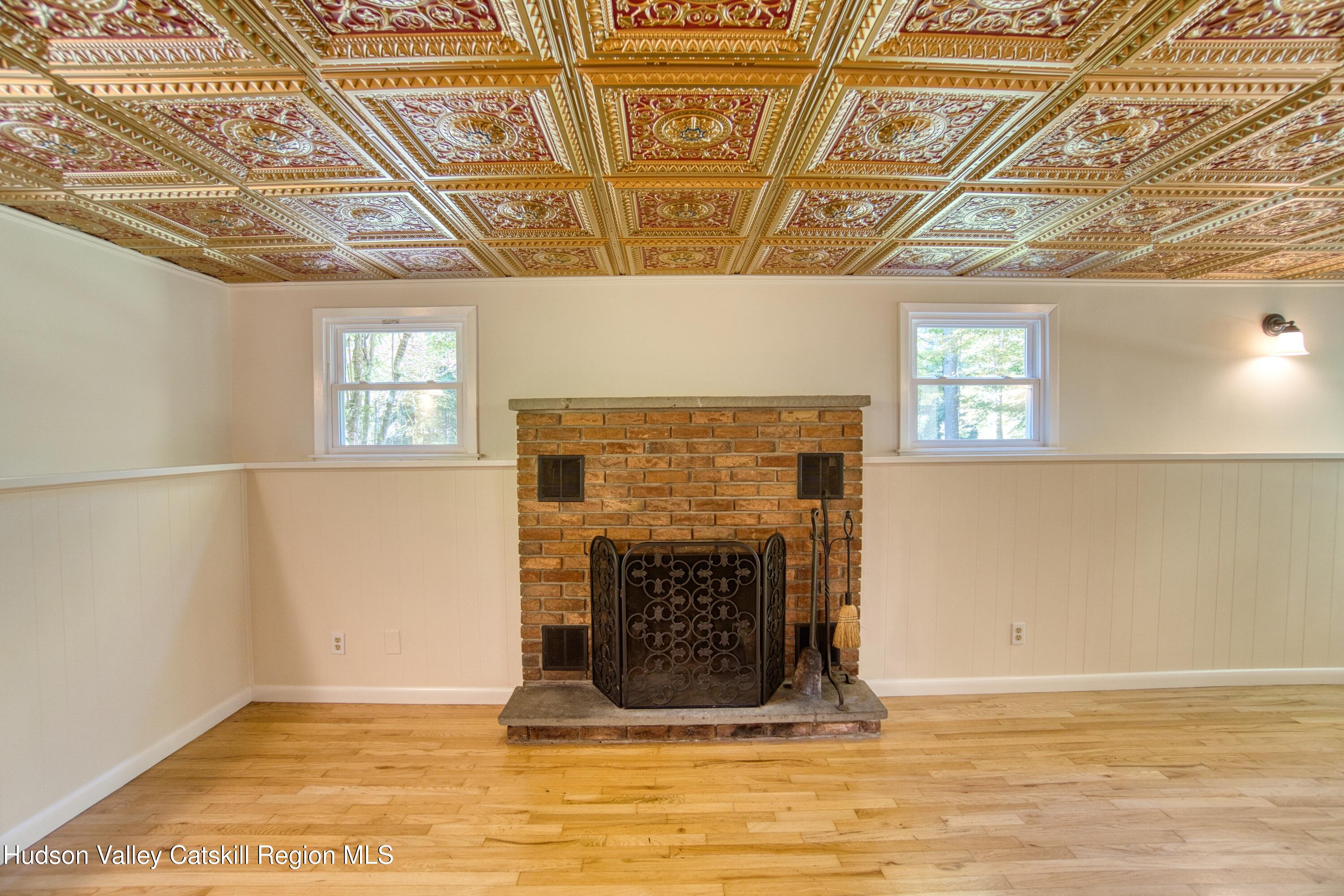 177 Buck Road Stone Ridge, NY 12484 - Photo 21 of 37 a living room with a fireplace and a wooden floor
