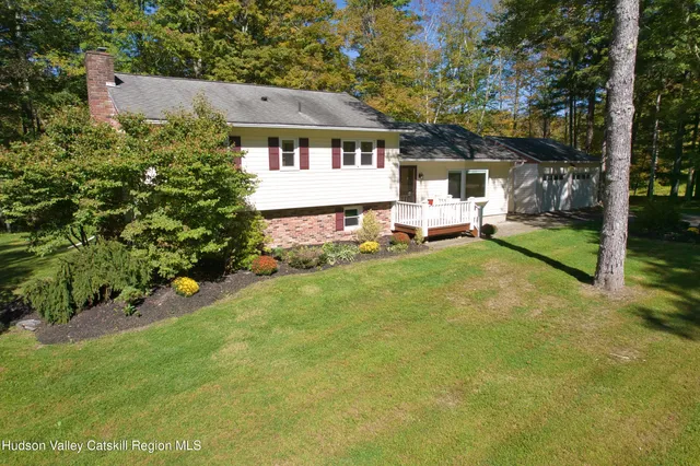 a view of a house with backyard sitting area and garden