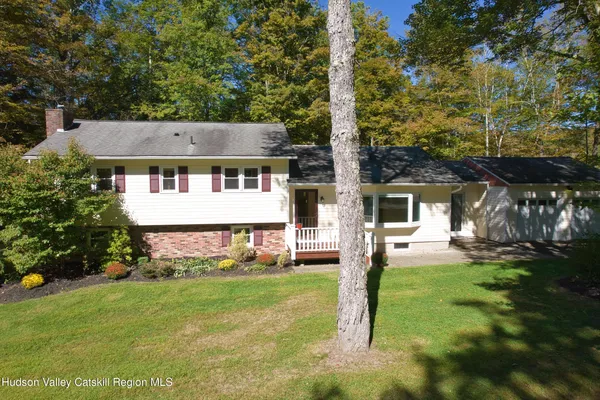 a view of a house with backyard sitting area and garden