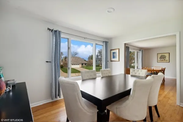 a view of a dining room with furniture and wooden floor