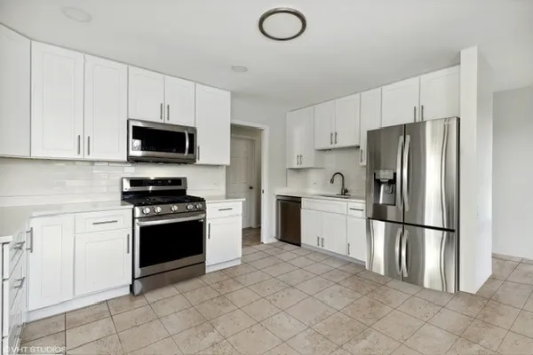 a kitchen with stainless steel appliances granite countertop a refrigerator stove a sink and dishwasher