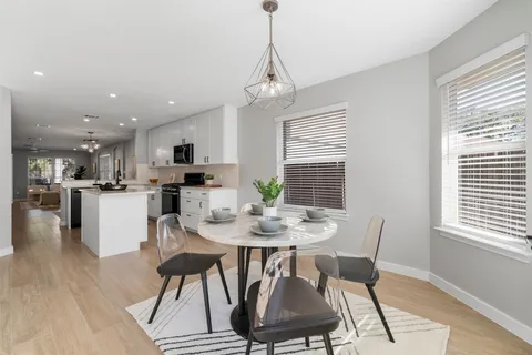 a view of a dining room with furniture window and wooden floor