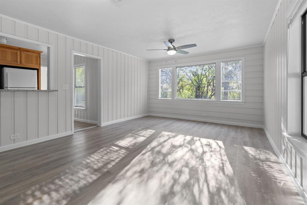 217 Clinton Drive Weatherford, TX 76086 - Photo 5 of 19 an empty room with wooden floor chandelier and windows