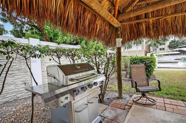 a view of a patio with table and chairs with wooden floor and plants