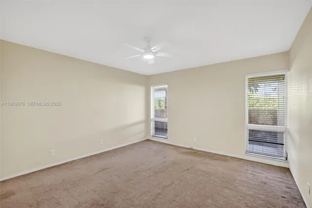 an empty room with a empty space and windows