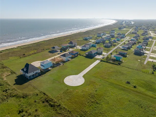 an aerial view of a residential houses with outdoor space