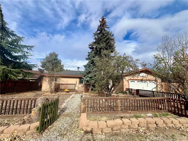a view of a house with wooden fence