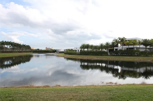 a view of a lake with houses in the back