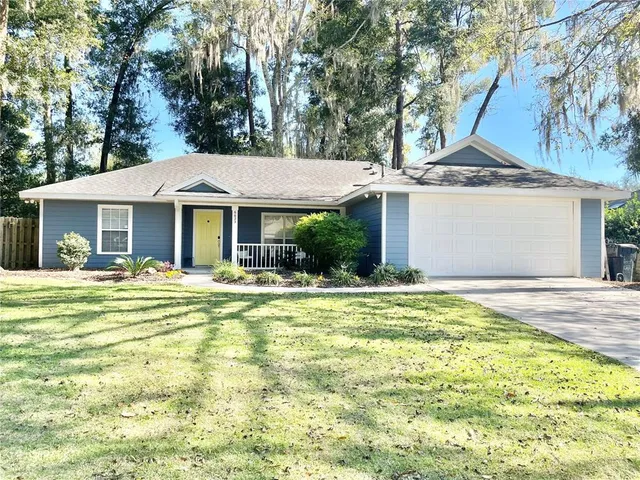 a view of a house with pool and a yard
