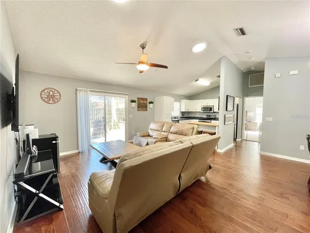 a view of a dining room with furniture and chandelier