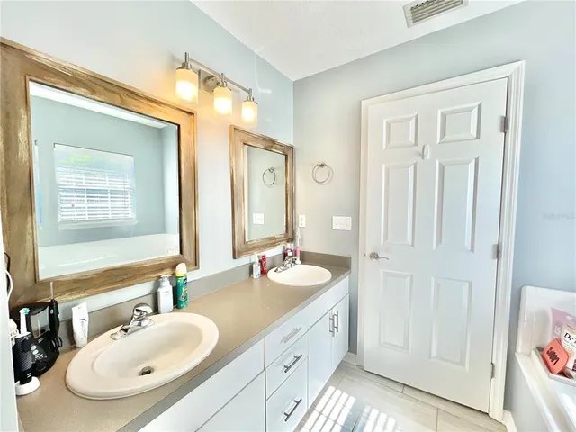 a bathroom with bathtub and window