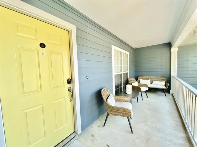 a view of a yard with plants and large trees