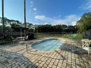 a living room with lots of wooden furniture and a table