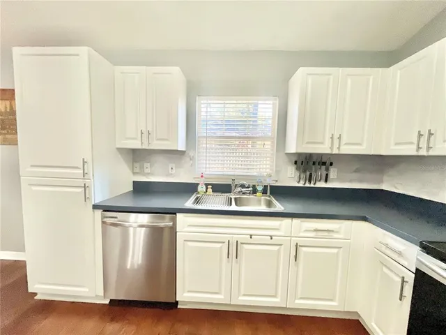 a kitchen with stainless steel appliances granite countertop a stove and a sink