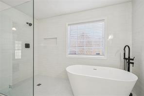 198 Celestial Run Winder, GA 30680 - Photo 15 of 30 a bathroom with a bathtub and a shower
