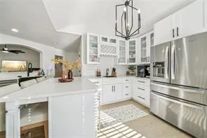a kitchen with stainless steel appliances a refrigerator sink and cabinets