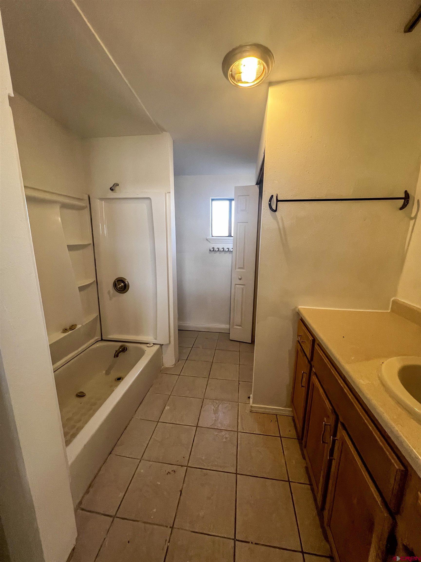 3350 County Road 319 Ignacio, CO 81137 - Photo 12 of 14 a bathroom with a sink a toilet and shower