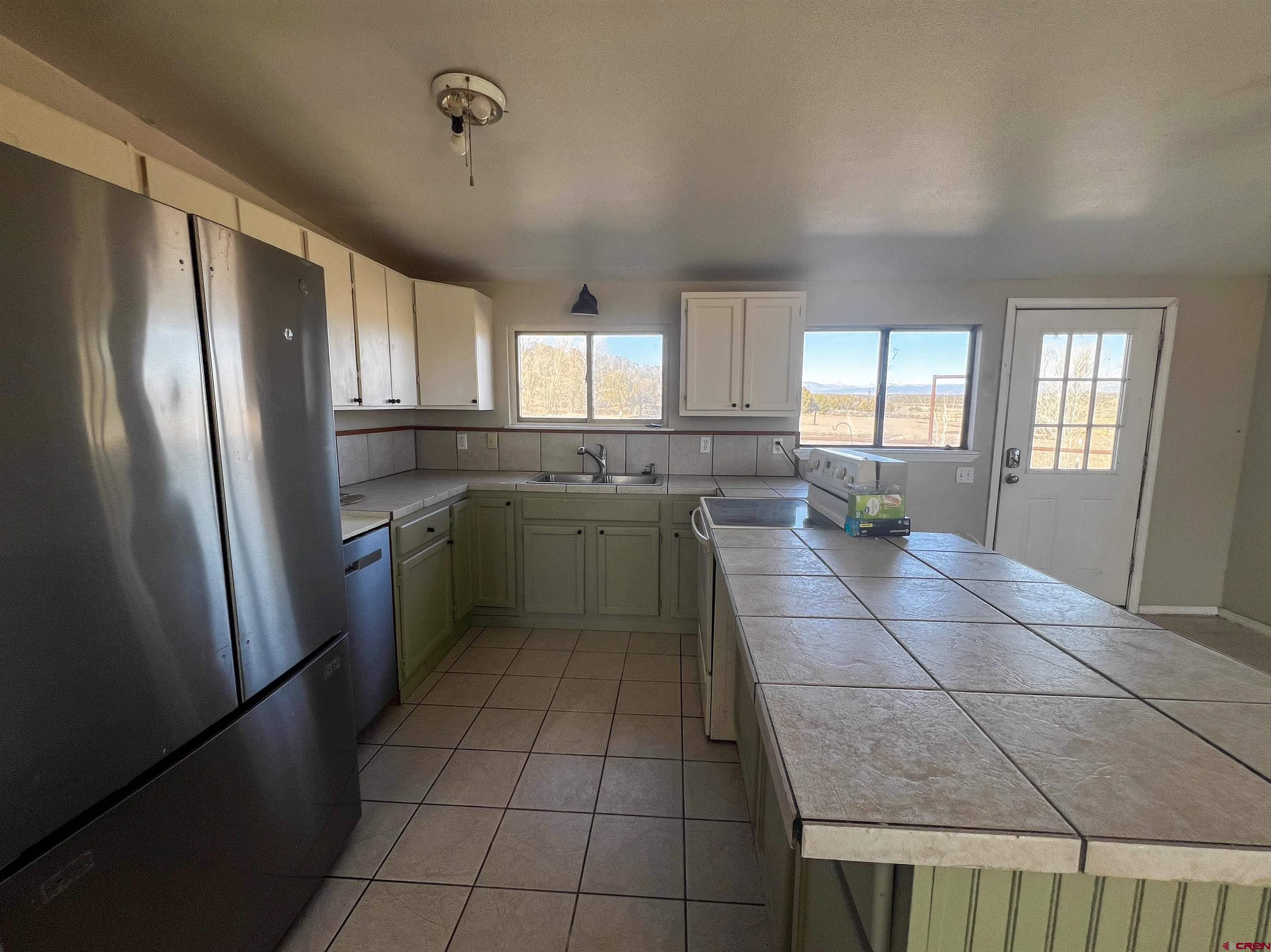 3350 County Road 319 Ignacio, CO 81137 - Photo 9 of 14 a kitchen with stainless steel appliances a refrigerator sink and cabinets