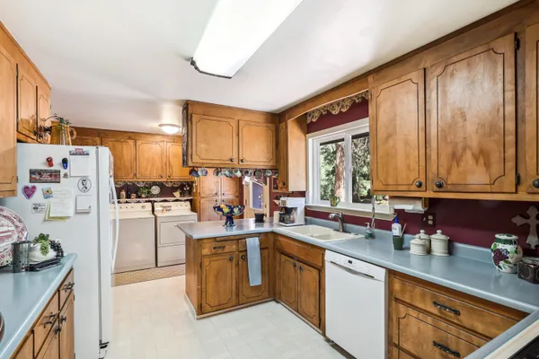 a kitchen with stainless steel appliances granite countertop a sink and a cabinets