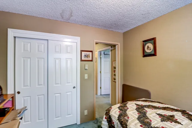 a bedroom with bed and a window