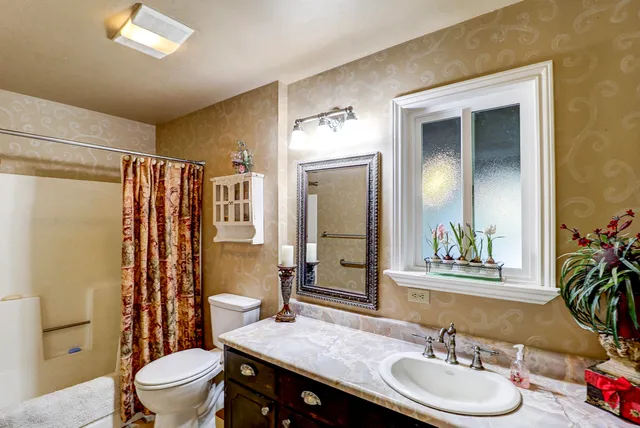 a bedroom with furniture and a chandelier