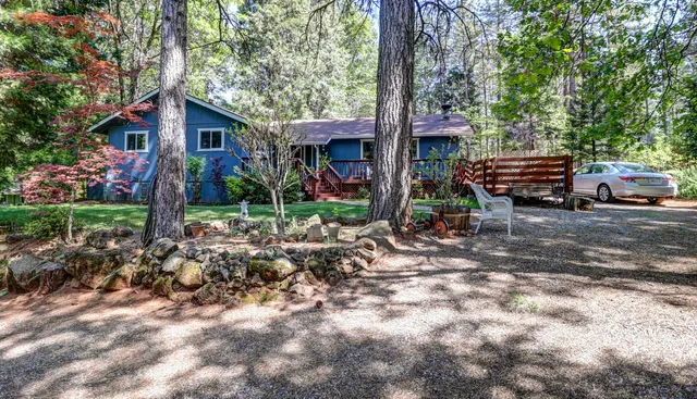 a view of a patio with table and chairs with wooden floor and fence