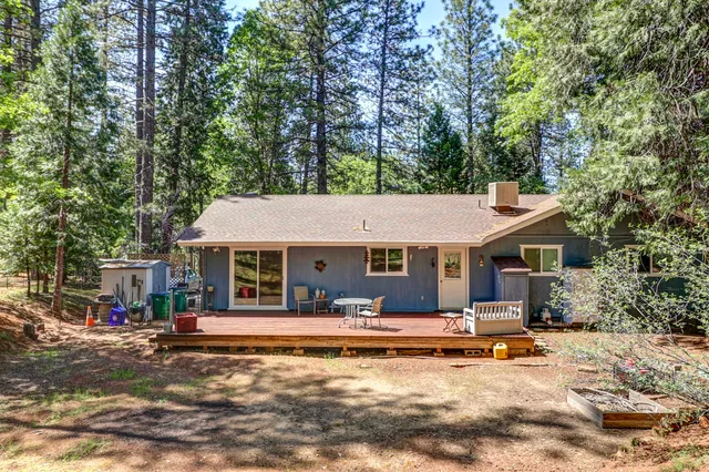 a view of dirt yard with a trees