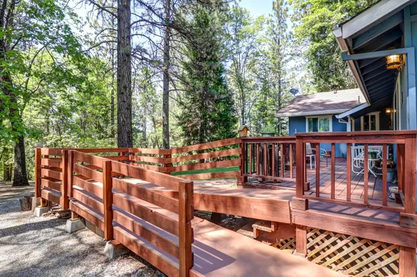 a view of a wooden deck and a backyard