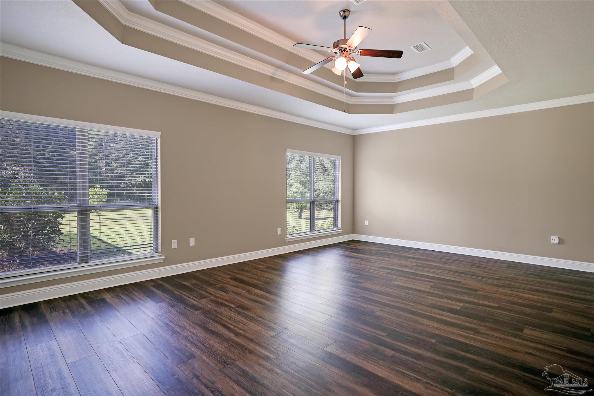 5847 Mossy Creek Lane Pace, FL 32571 - Photo 16 of 50 a view of an empty room with wooden floor and a window