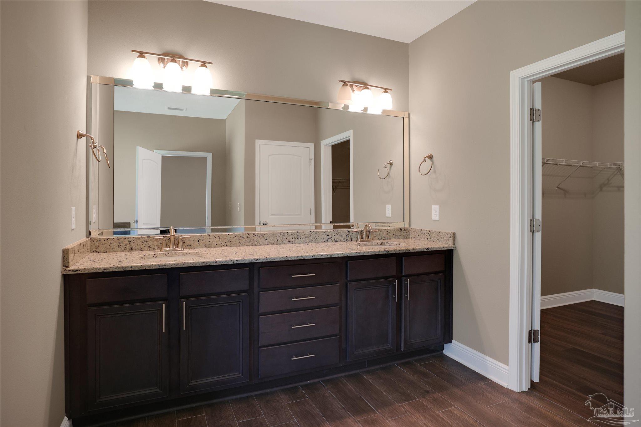 5847 Mossy Creek Lane Pace, FL 32571 - Photo 18 of 50 a bathroom with double vanity sinks and a mirror