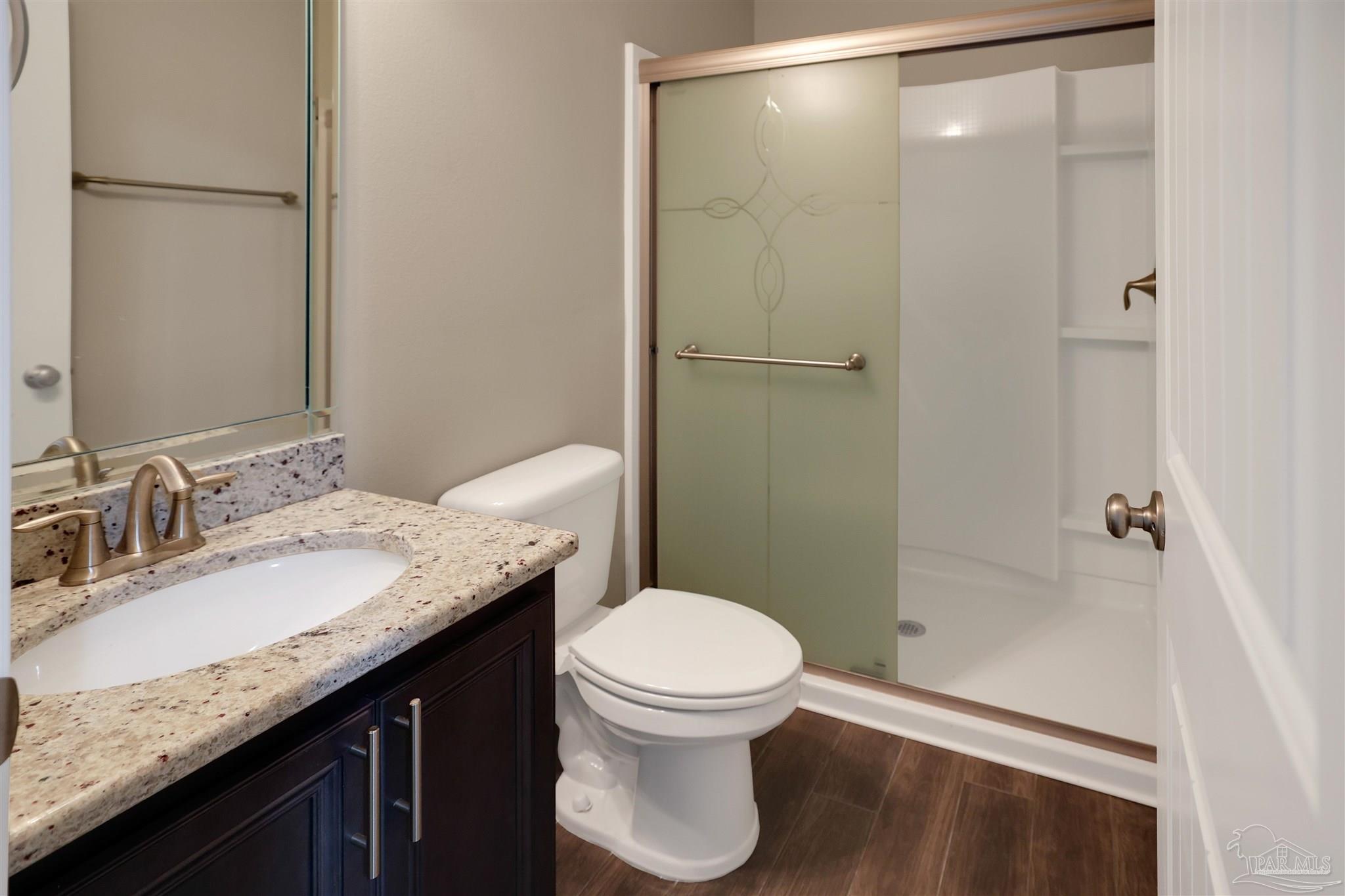 5847 Mossy Creek Lane Pace, FL 32571 - Photo 24 of 50 a bathroom with a granite countertop sink toilet and shower