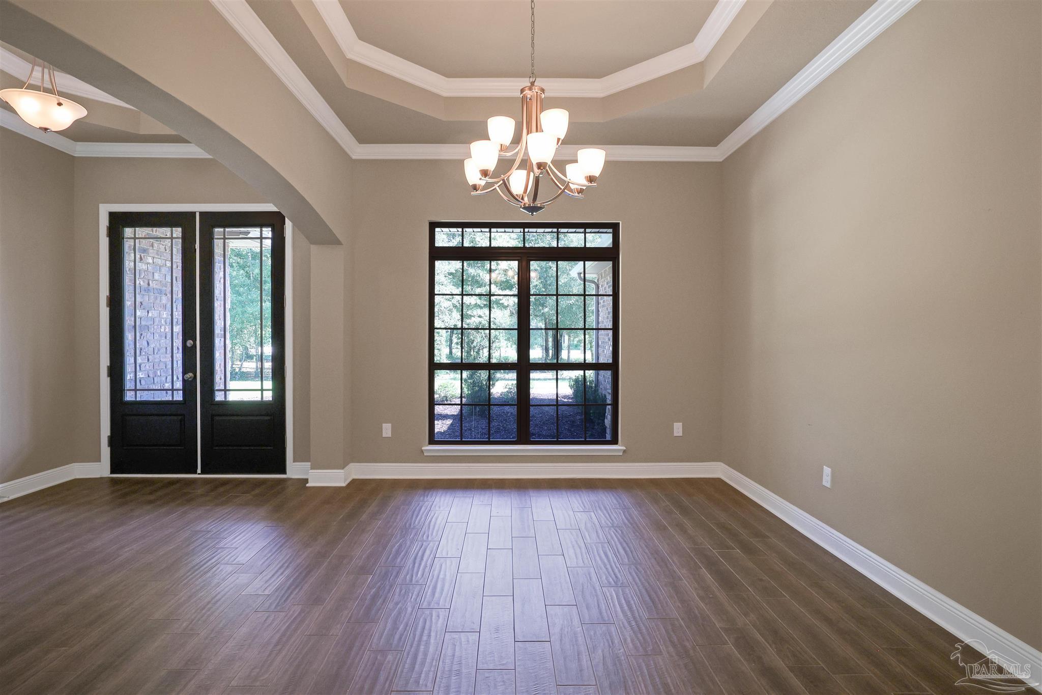 5847 Mossy Creek Lane Pace, FL 32571 - Photo 26 of 50 a view of an empty room with wooden floor and a window