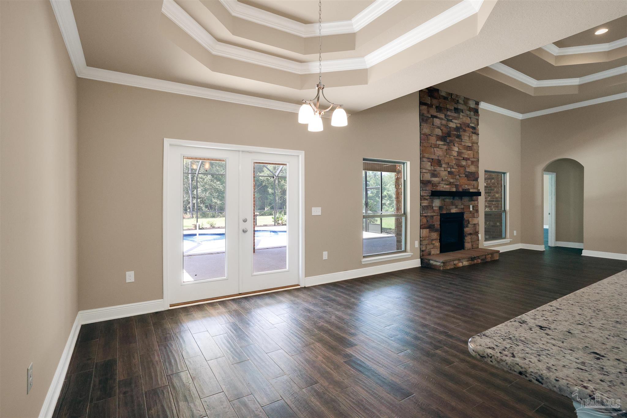 5847 Mossy Creek Lane Pace, FL 32571 - Photo 28 of 50 a view of empty room with wooden floor and fireplace