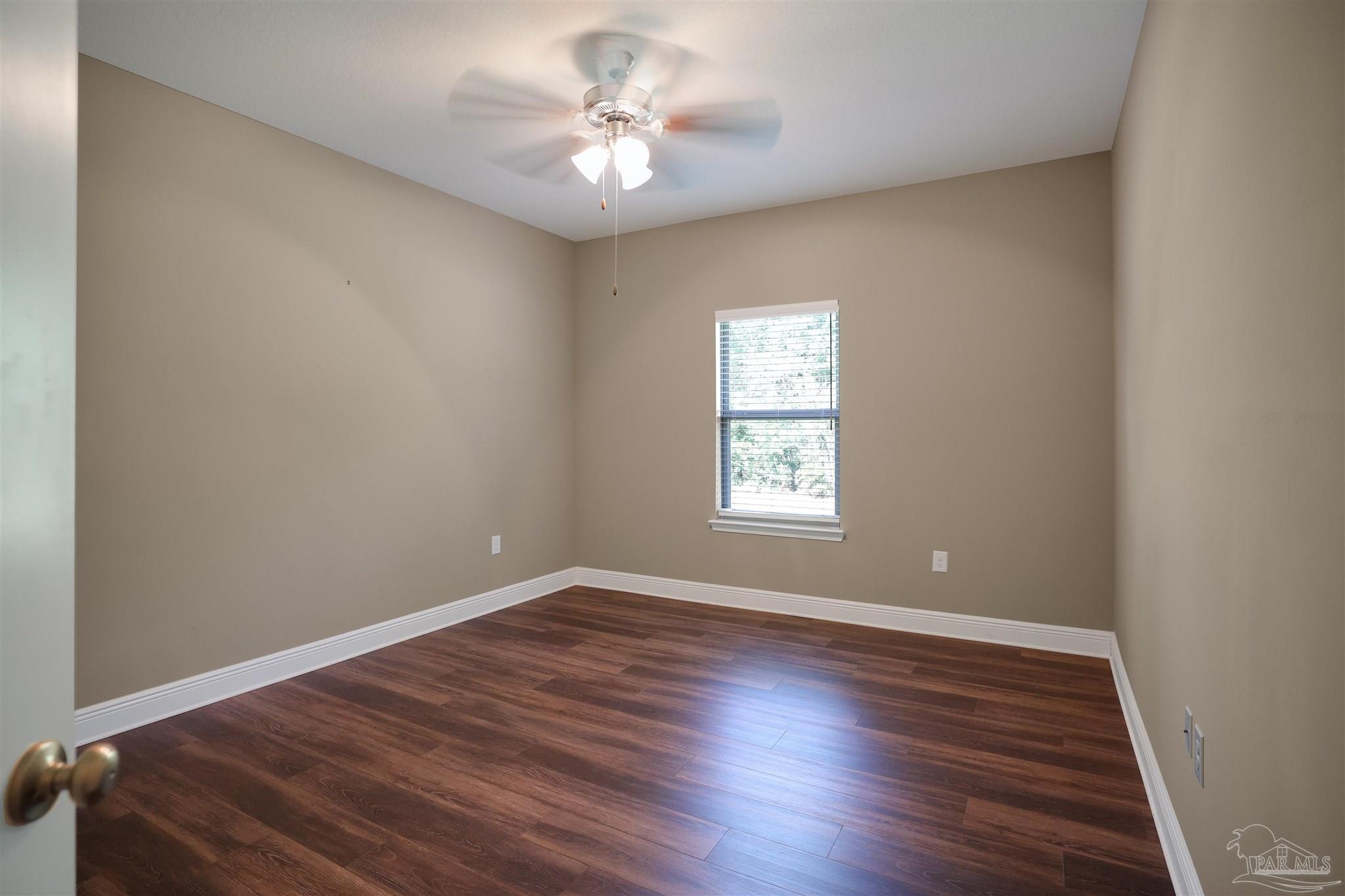 5847 Mossy Creek Lane Pace, FL 32571 - Photo 30 of 50 an empty room with wooden floor and window